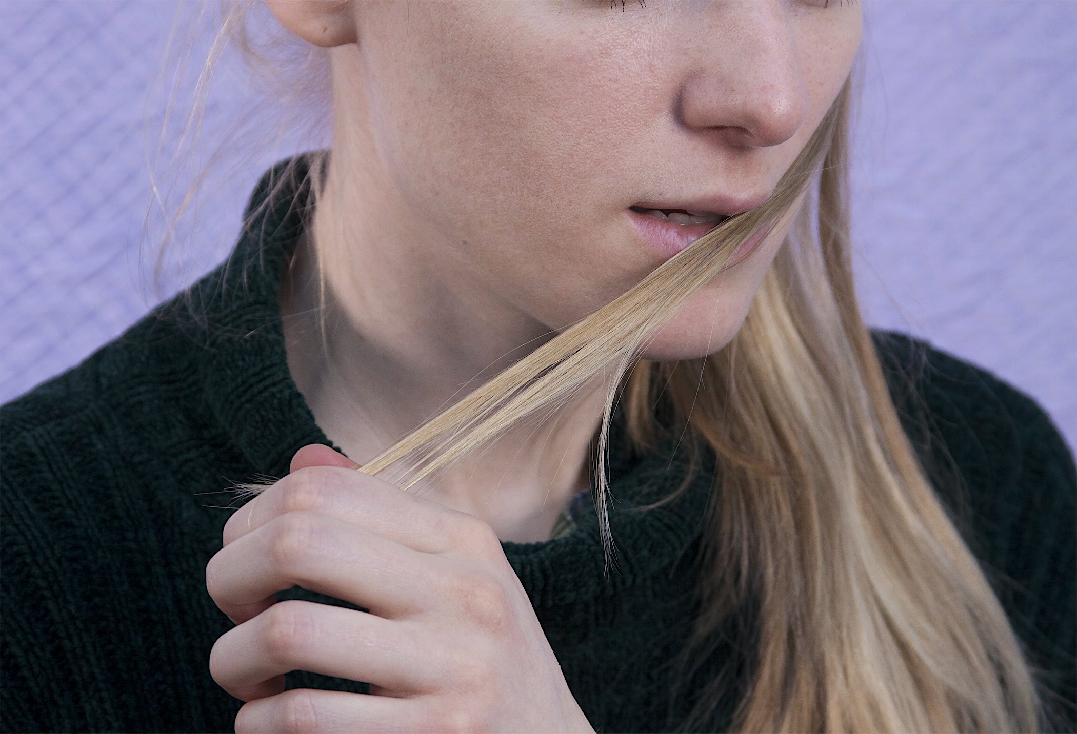 fake rope, coiled on a platform, partially covering an image of a woman